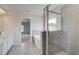 Bright bathroom showcasing a modern vanity, soaking tub, and glass-enclosed shower with gray tiling at 119 Felicity Pike, Locust Grove, GA 30248