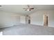 Spacious carpeted bedroom with a ceiling fan and neutral color palette, ready for personalization and comfort at 119 Felicity Pike, Locust Grove, GA 30248