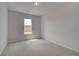 Bright, carpeted bedroom with a large window offering ample natural light at 119 Felicity Pike, Locust Grove, GA 30248