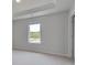 A well-lit bedroom with neutral carpet, trim detail, and a bright window at 119 Felicity Pike, Locust Grove, GA 30248