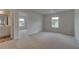 Bedroom with neutral carpet, a window, and an adjoining bathroom at 119 Felicity Pike, Locust Grove, GA 30248