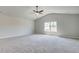 Carpeted Primary bedroom with ceiling fan and large window offering lots of natural light at 119 Felicity Pike, Locust Grove, GA 30248