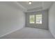Bedroom featuring plush carpet, a tray ceiling, and a window at 119 Felicity Pike, Locust Grove, GA 30248