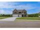 Charming two-story brick home with a well-manicured lawn and a three-car garage at 119 Felicity Pike, Locust Grove, GA 30248