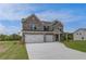 Elegant two-story brick home with a three-car garage and well-maintained landscaping at 119 Felicity Pike, Locust Grove, GA 30248
