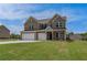Attractive brick home with a three-car garage and a lush green lawn at 119 Felicity Pike, Locust Grove, GA 30248