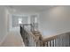 A hallway with a decorative stair railing and carpet at 119 Felicity Pike, Locust Grove, GA 30248