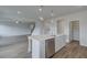 Open kitchen design with an island, stainless steel dishwasher, and view to living room at 119 Felicity Pike, Locust Grove, GA 30248