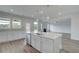 Open kitchen design with an island, stainless steel dishwasher, and hard surface countertops at 119 Felicity Pike, Locust Grove, GA 30248
