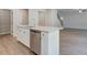 Kitchen island with stainless dishwasher, granite countertops and an open view to the living area at 119 Felicity Pike, Locust Grove, GA 30248