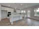 Well-lit kitchen featuring an island, stainless steel appliances, and ample cabinet space at 119 Felicity Pike, Locust Grove, GA 30248