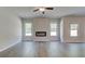 Bright living room with fireplace and large windows providing lots of natural light at 119 Felicity Pike, Locust Grove, GA 30248