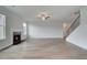 Spacious living room with a fireplace, ceiling fan, and staircase at 119 Felicity Pike, Locust Grove, GA 30248
