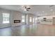 Bright open-concept living room with fireplace and hardwood floors flowing into the kitchen at 119 Felicity Pike, Locust Grove, GA 30248
