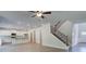 Open concept living space connects kitchen and staircase, with bright natural light at 119 Felicity Pike, Locust Grove, GA 30248