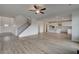 Spacious open-plan living room with a staircase, hardwood floors, and bright kitchen at 119 Felicity Pike, Locust Grove, GA 30248