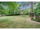 Spacious backyard with a well-maintained lawn, mature trees, and brick pathway at 1292 Marcelle Heights Nw Pl, Norcross, GA 30093
