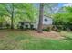 View of the house from the backyard showcasing the yard and trees around the property at 1292 Marcelle Heights Nw Pl, Norcross, GA 30093