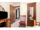 Cozy bedroom featuring neutral walls, wooden doors, and a chair with a red cushion at 1292 Marcelle Heights Nw Pl, Norcross, GA 30093