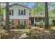 Charming two-story home with a brick and gray exterior, complemented by a welcoming front porch at 1292 Marcelle Heights Nw Pl, Norcross, GA 30093