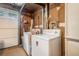 Laundry area with a white washer and dryer set next to a garage door and storage at 1292 Marcelle Heights Nw Pl, Norcross, GA 30093
