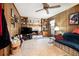 Cozy living room with wood paneling, stone fireplace, ceiling fan, and built-in shelving for a relaxed atmosphere at 1292 Marcelle Heights Nw Pl, Norcross, GA 30093