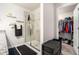 Modern bathroom with a glass-enclosed shower and a peek into the walk-in closet at 1868 Fabian Way, Austell, GA 30106