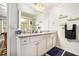Bright bathroom with double sink vanity, granite countertop, and large mirror at 1868 Fabian Way, Austell, GA 30106
