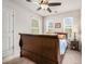 Well-lit bedroom with ceiling fan, neutral carpet, and two windows at 1868 Fabian Way, Austell, GA 30106