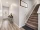Bright entryway with stylish wood floors, a staircase, and a decorative table, perfect for welcoming guests at 1868 Fabian Way, Austell, GA 30106
