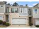 Charming townhome with brick and siding facade, featuring a one-car garage and well-maintained landscaping at 1868 Fabian Way, Austell, GA 30106