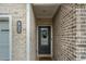 Inviting entryway featuring a decorative wreath, a brick wall, and a clear address plaque at 1868 Fabian Way, Austell, GA 30106