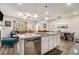 Open-concept kitchen with a large island, modern appliances, and seamless flow into the living and dining areas at 1868 Fabian Way, Austell, GA 30106