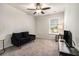Cozy living room featuring a plush couch, ceiling fan, and window at 1868 Fabian Way, Austell, GA 30106