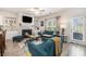 Cozy living room with a fireplace, a ceiling fan, and ample natural light, creating a comfortable atmosphere at 1868 Fabian Way, Austell, GA 30106