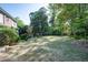 Large backyard featuring a well-maintained lawn, mature trees, and lush greenery at 2340 Castleridge Ct, Tucker, GA 30084