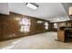 Spacious basement with wood paneling, a bar area, and colorful window accents at 2340 Castleridge Ct, Tucker, GA 30084
