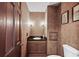 Elegant bathroom with decorative wall tiles, vanity with dark countertop and classic fixtures at 2340 Castleridge Ct, Tucker, GA 30084