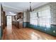 Traditional dining room with hardwood floors and floral wallpaper adjacent to the kitchen at 2340 Castleridge Ct, Tucker, GA 30084