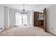 Bright, carpeted dining room showcasing a chandelier and large windows, connected to the kitchen at 2340 Castleridge Ct, Tucker, GA 30084