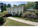 Traditional two-story home with a brick chimney, white siding, and a well-manicured front yard at 2340 Castleridge Ct, Tucker, GA 30084