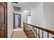 Hallway with wooden railing and multiple doors leading to different rooms in the home at 2340 Castleridge Ct, Tucker, GA 30084