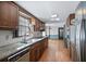 Well-lit kitchen featuring granite countertops, white backsplash, stainless appliances, and wooden cabinetry at 2340 Castleridge Ct, Tucker, GA 30084