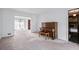 Open-concept living room featuring a piano and a view into an adjacent room with chandelier at 2340 Castleridge Ct, Tucker, GA 30084