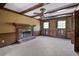 Cozy living room with wood-paneled walls, beamed ceiling, a brick fireplace, and ample natural light at 2340 Castleridge Ct, Tucker, GA 30084