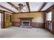 Spacious living room featuring beamed ceilings, a brick fireplace, and ample windows for natural light at 2340 Castleridge Ct, Tucker, GA 30084