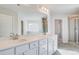 Spacious bathroom featuring dual sinks, large mirror, walk-in glass shower, and tile floors at 115 Felicity Pike, Locust Grove, GA 30248