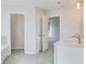 Well-lit bathroom with double sinks and doors leading to shower and bedroom at 115 Felicity Pike, Locust Grove, GA 30248