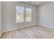 Bright bedroom with hardwood floors, neutral walls, and natural light from the double windows at 115 Felicity Pike, Locust Grove, GA 30248