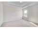 Spacious bedroom with a tray ceiling, carpet, natural light and neutral walls at 115 Felicity Pike, Locust Grove, GA 30248